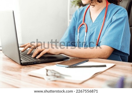 doctor using computer, nurse work on laptop.