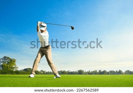 Asian man golfer driver swing before hitting golf ball down the fairway. Royalty-Free Stock Photo #2267562589