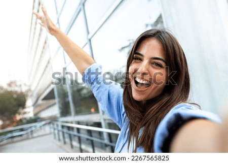 Young caucasian brunette woman taking selfie looking at camera. Copy space.