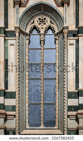 Ornate colorful marble facade of the Duomo Cathedral or Cattedrale di Santa Maria del Fiore, Florence, Italy known for the red tiled Brunelleschi dome