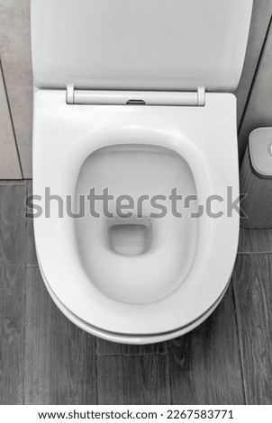 Open lavatory bowl at toilet. Top view. Royalty-Free Stock Photo #2267583771