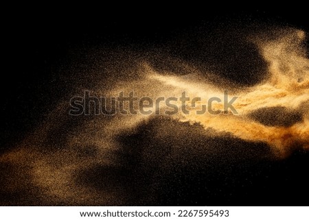 Sand explosion isolated on black background. Freeze motion of sandy dust splash.Sand texture concept.