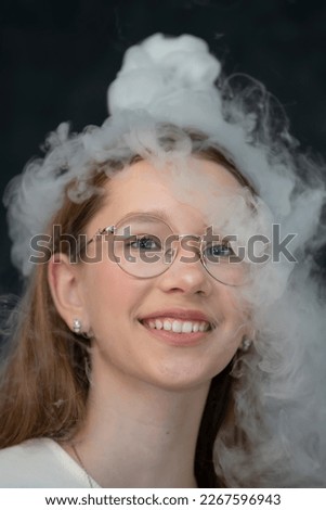 The child is a participant in scientific experiments. Girl in liquid nitrogen smoke.