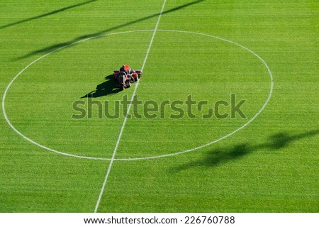 Mowing grass on the football stadium