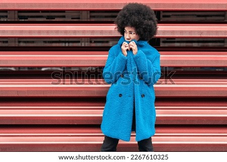 Stock photo of serious african american girl posing and looking to the side.
