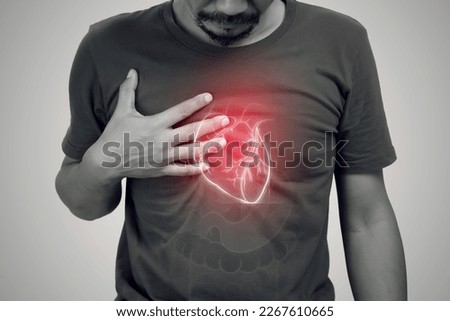 Heart failure of asian man on a gray background. Royalty-Free Stock Photo #2267610665
