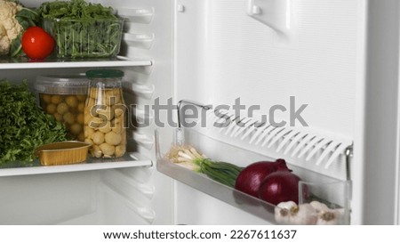 Open refrigerator full of many different products