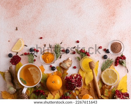 Flat lay composition with cup of delicious immunity boosting tea and ingredients on color textured background. Space for text