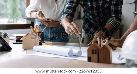 engineer and architect people meeting working and hand drawing on blueprint and briefing with his colleague. Engineering tools and construction concept