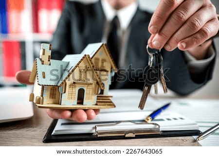 Real estate agent  work with documents for dsle property. Concept of home insurance and investment loan