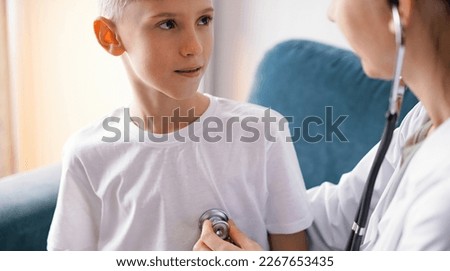 Doctor and kid boy at home. Child patient at usual medical inspection. Medicine, healthcare concepts.