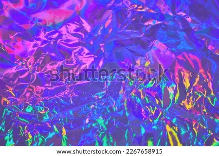 Abstract holographic background in 80s, 90s style. Modern bright neon colored metallic psychedelic holographic foil texture. Synthwave, vaporwave, retrowave, retro futurism, webpunk, syberpunk