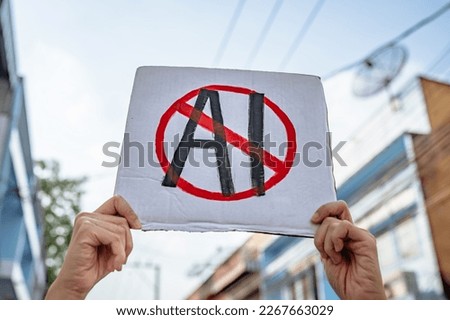 Demonstrator holding "No AI" placard Royalty-Free Stock Photo #2267663029