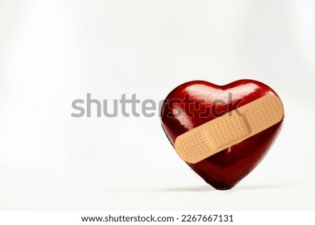 Broken heart shape with bandage on white background with copy space, medical,health, broken love,heart broken illness concept