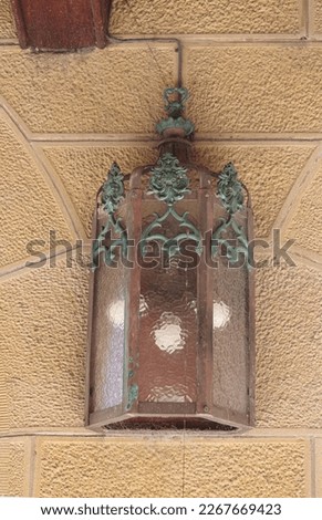 A light fitting on a Victorian Academic Gothic Revival style sandstone building. 