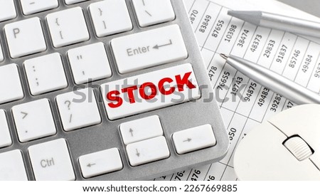 STOCK text on keyboard wirh chart and pencil