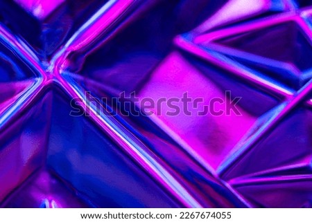 Abstract background of colored lines and rectangular shapes. Shot of an illuminated embossed glass surface.