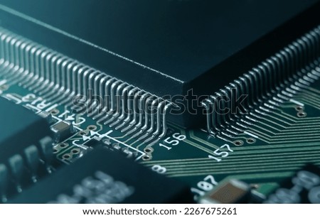 Macro photo of application specific integradet circuit in QFP package mounted on printed circuit board Royalty-Free Stock Photo #2267675261