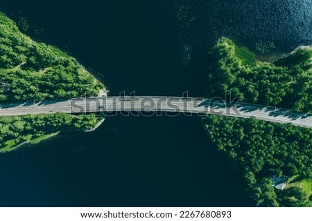 Aerial view of bridge road through blue lakes with green woods in summer Finland. Royalty-Free Stock Photo #2267680893