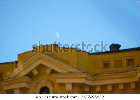 month. the moon and the facade of a building. selective focus. daytime photo.