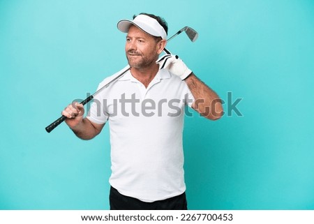 Middle age caucasian golfer player man isolated on blue background having doubts