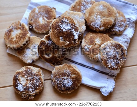 Home made welsh cakes presented on striped linen cloth
