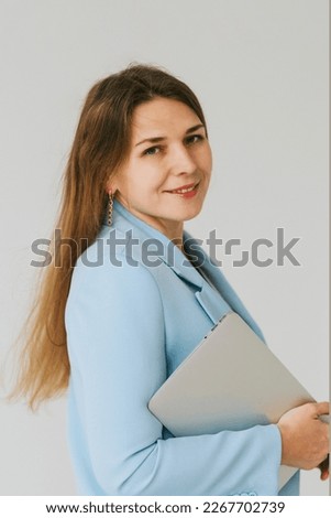 beautiful middle aged real woman portrait with laptop on white background, professional and selfmade businesswoman working online
