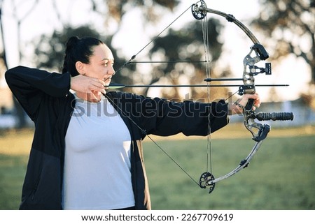 Hobby, learning and woman playing archery as a sport, outdoor activity and game in nature of France. Training, practice and girl with a bow and arrow for sports, competition and shooting at a park Royalty-Free Stock Photo #2267709619