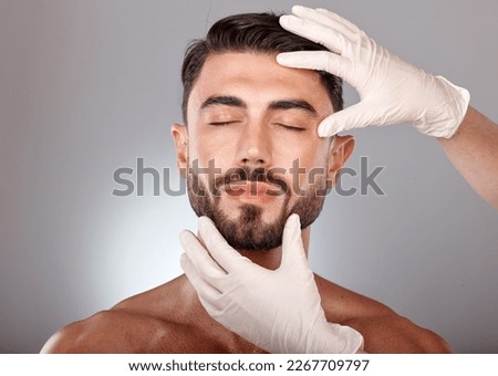 Plastic surgery, cosmetics and man with doctor hands in studio mockup , aesthetic or facial dermatology for medical or beauty. Mesotherapy, hyaluronic acid or collagen of young model face Royalty-Free Stock Photo #2267709797
