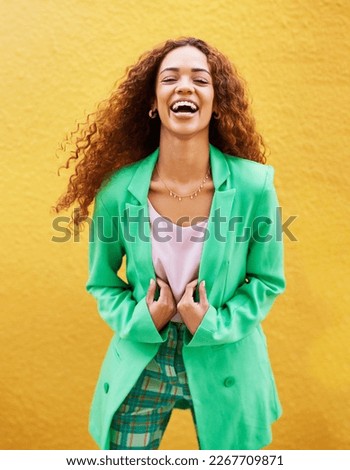 Portrait, fashion and woman laughing on yellow background, color wall and backdrop with smile in Colombia. Happy young female, trendy style and green clothes for beauty, curly hair and gen z model Royalty-Free Stock Photo #2267709871