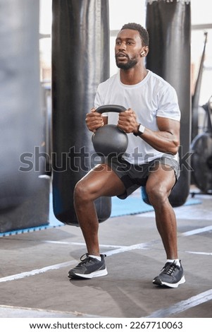 Black man, gym and kettlebell for squat exercise, weightlifting workout or muscle growth training. African bodybuilder, wellness trainer and metal weights for strong legs, body development or health