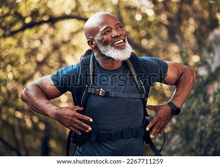 Fitness, hiking and black man backpacking in nature in a forest for exercise, health and wellness. Sports, athlete and happy senior African male in retirement trekking in the woods on adventure trail