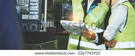 engineer factory inspection computer control with hand robot ai machine assist production engineer in industry She, He wears a helmet man working metalwork control in industrial plastic factory Royalty-Free Stock Photo #2267741923
