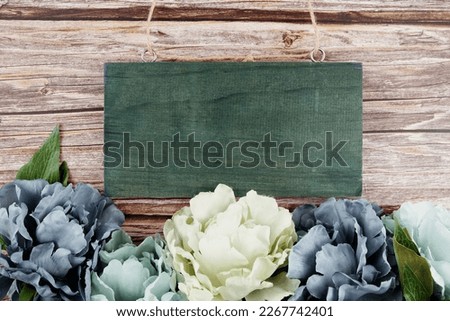Blue peony flowers border frame on wooden background