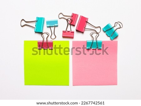 On a white background there are two stickers with a place to insert text and multi-colored paper clips