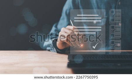 a man reviewing and managing business documents and agreements online,signing a business contract approval of contract documents confirmation or warranty certificate,employment idea, project review Royalty-Free Stock Photo #2267750395