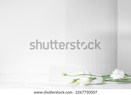 Summer minimal scene for beauty cosmetic product presentation made with white cube podium and Lysianthus flower on white background.