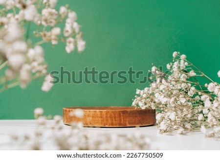 Product presentation scene made with wooden pedestal and summer flowers, front view. Royalty-Free Stock Photo #2267750509