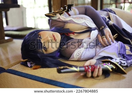 Portrait of a beautiful young woman game cosplay with samurai dress costume sleeping at japanese room