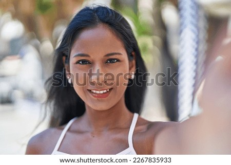 Young beautiful woman smiling confident making selfie by camera at park