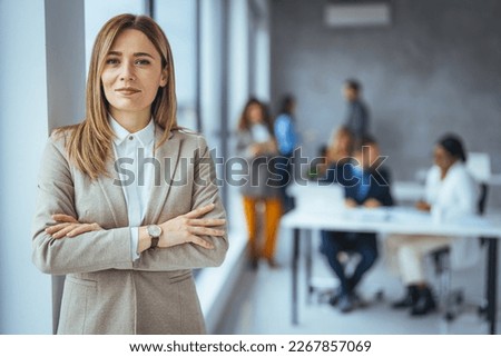 Portrait of a confident mature businesswoman working in a modern office. Cropped portrait of an attractive young businesswoman standing in her office with her arms folded during the day