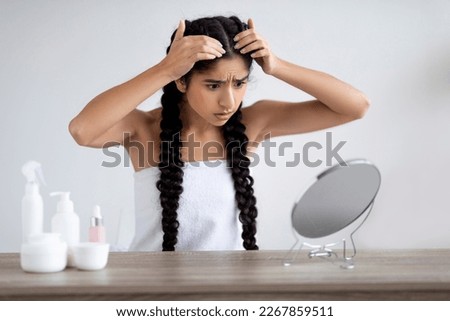 Dandruff Problem. Upset Young Indian Woman Looking To Mirror At Her Hair Roots, Shocked Hindu Female Suffering Dry Flaky Scalp After Bath, Having Problems With Haircare Routine, Copy Space Royalty-Free Stock Photo #2267859511