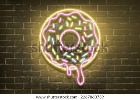 Doughnut glowing neon sign on brick wall