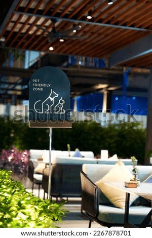 a pet-friendly cafe sign on a sunny summer terrace, inviting pet owners to relax and enjoy a meal with their furry friends. The warm, inviting atmosphere and picturesque surroundings