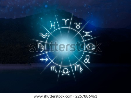 Zodiac wheel with 12 astrological signs and mountain landscape on background Royalty-Free Stock Photo #2267886461