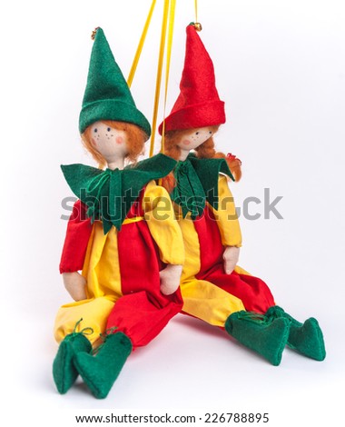Textile dolls clothed up in colorful costumes. Couple of clowns.
