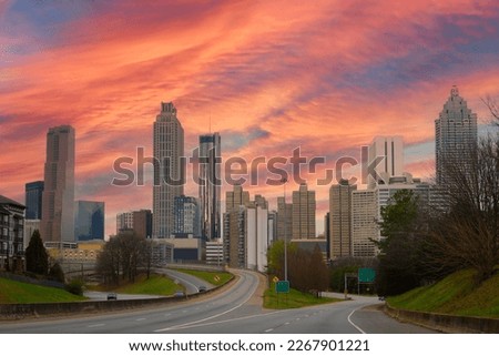 Atlanta City skyline with skyscrapers, buildings, and sunset clouds over the highway in the Capital of the U.S. State of Georgia