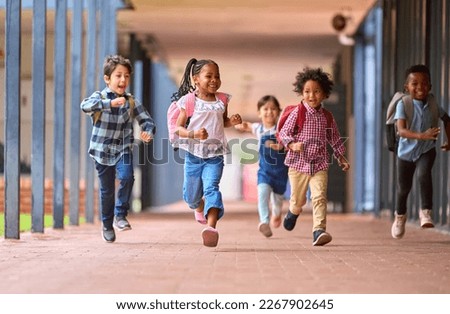 Group Of Multi-Cultural Elementary School Pupils Running Along Walkway Outdoors At School Royalty-Free Stock Photo #2267902645