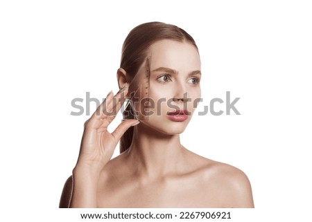 Young woman, female patient isolated on white studio background. Concept of lifting. Making beauty, modifying face to make non-surgical or surgical correction, plastic surgery. correction asymmetry. Royalty-Free Stock Photo #2267906921