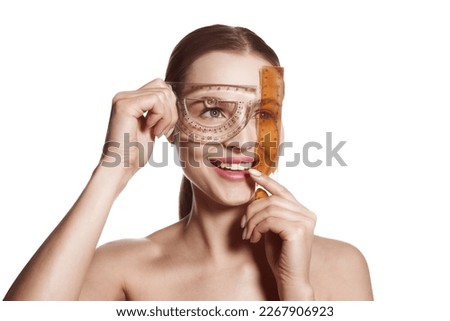 Making beauty, modifying face to make non-surgical or surgical correction, plastic surgery. correction of asymmetry. Young woman, female patient isolated on white studio background. Concept of lifting Royalty-Free Stock Photo #2267906923